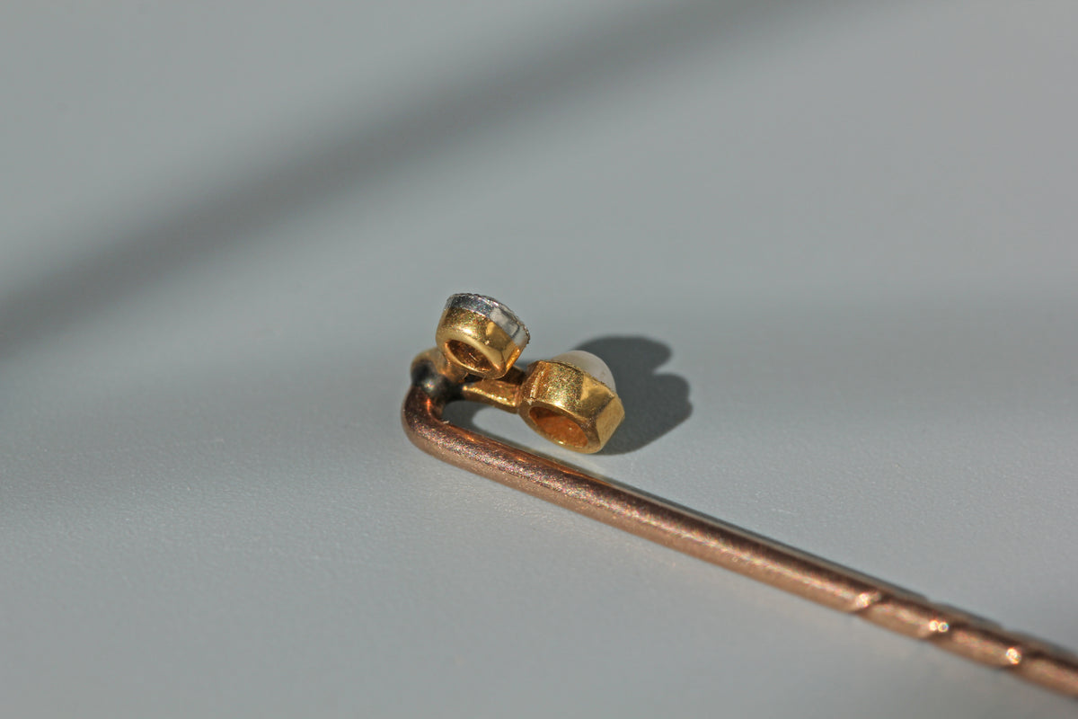 Antique old cut diamond and pearl toi et moi stick pin, in 18ct gold
