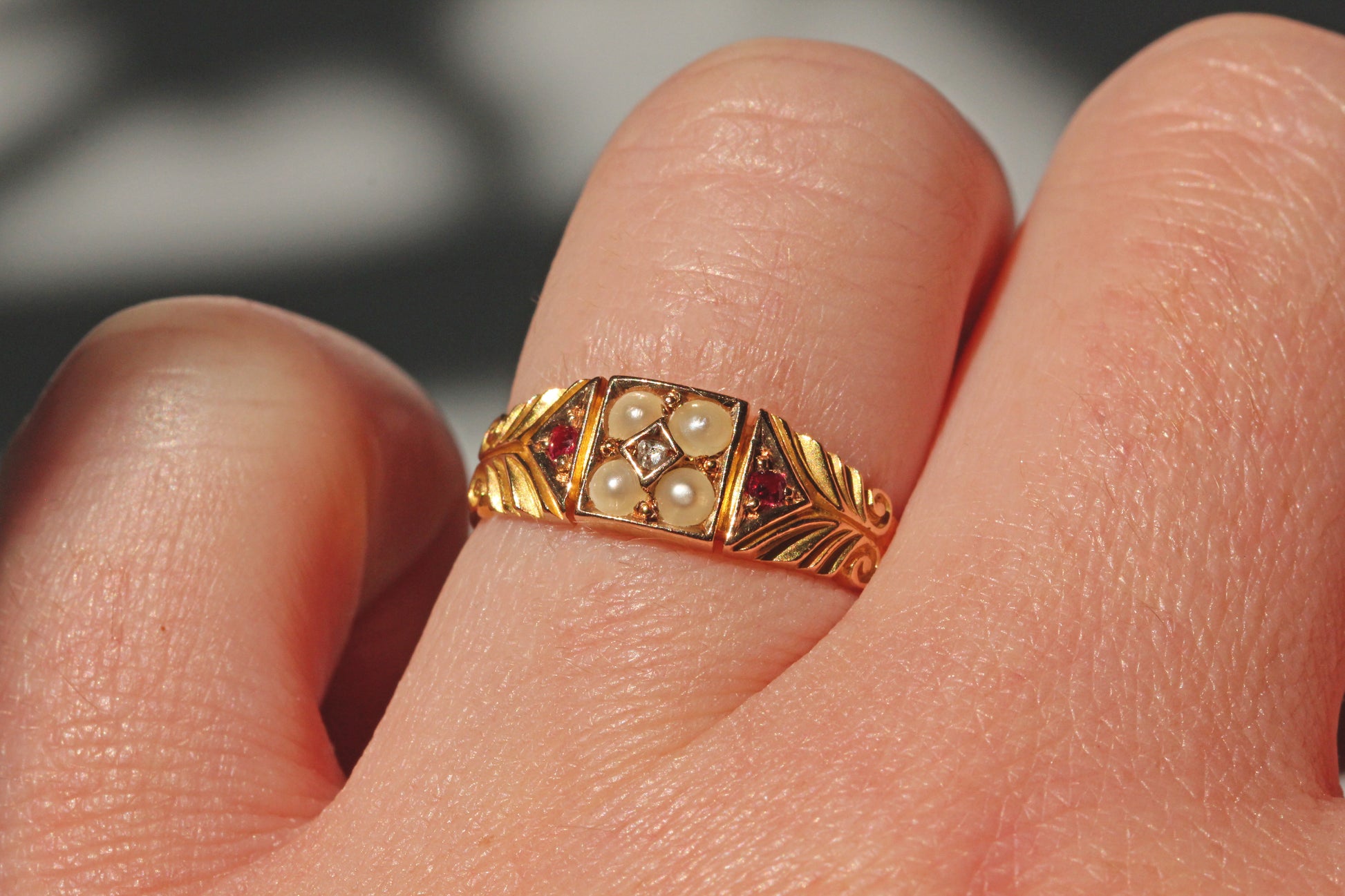 Victorian antique pearl diamond and ruby ring in 15ct gold on ring finger