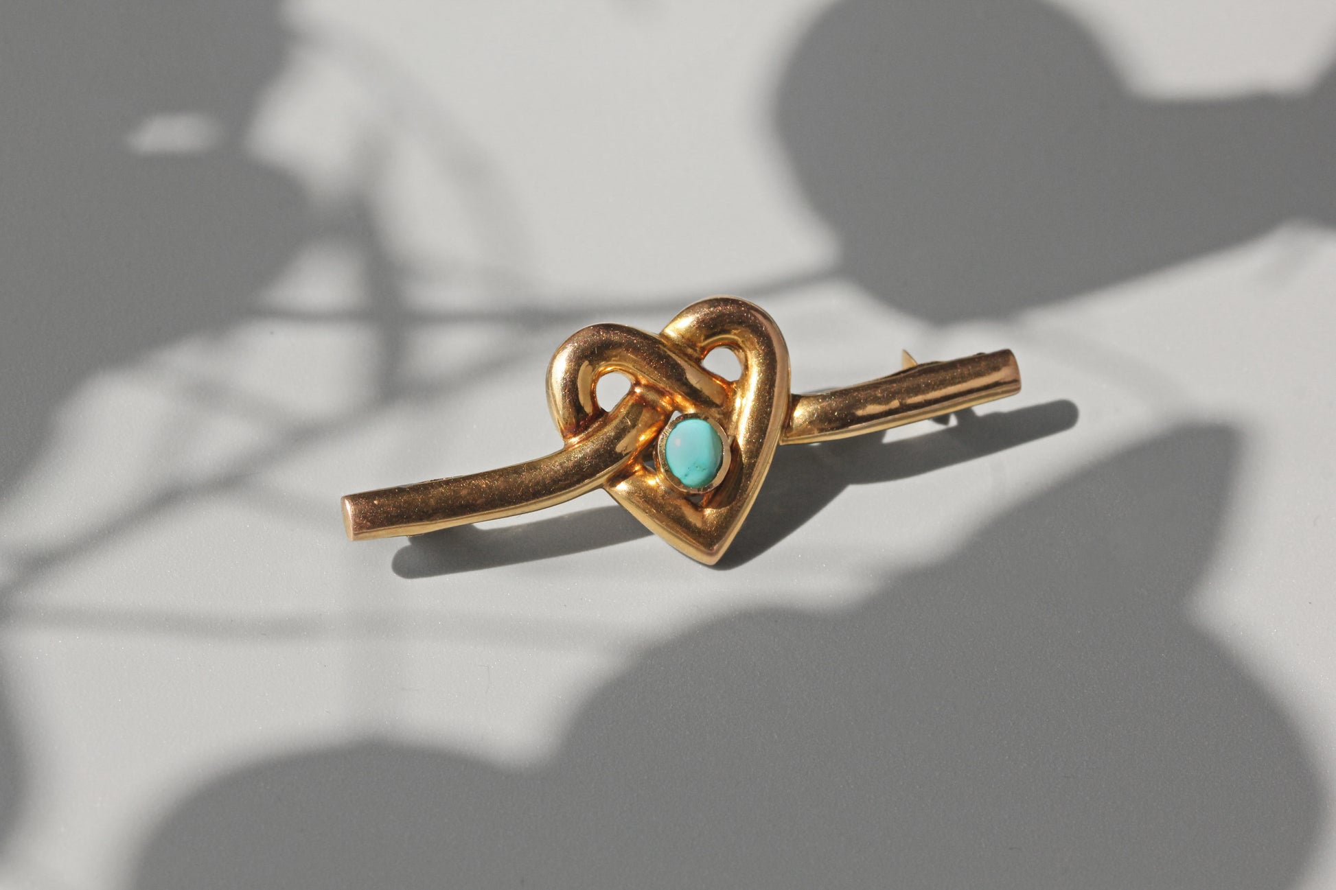 victorian lover's knot brooch in gold with turquoise stone