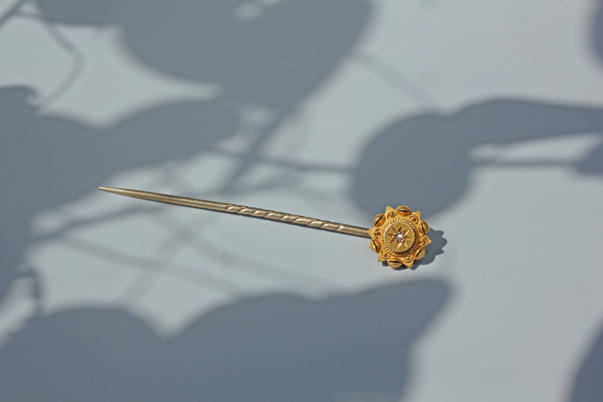 Victorian 15ct gold stick pin with old cut diamond starburst
