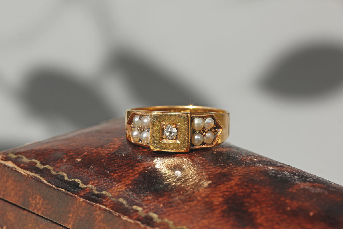 antique victorian 18ct old mine cut diamond band ring, with pearl shoulders displayed on antique jewellery box