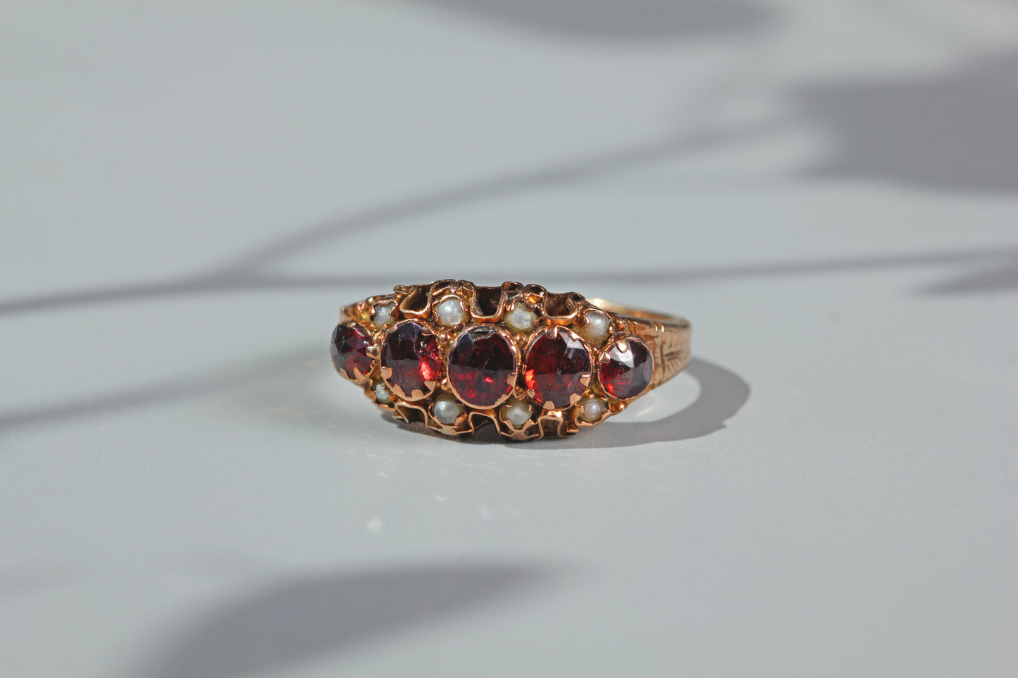 close up of antique half hoop ring with garnets