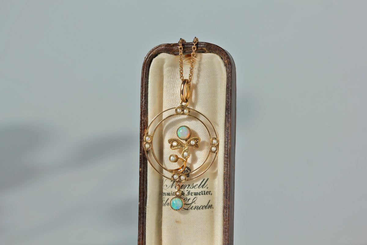 Antique 9ct gold edwardian era pendant on a 9ct antique cable chain, featuring opals and pearls upon an openwork frame