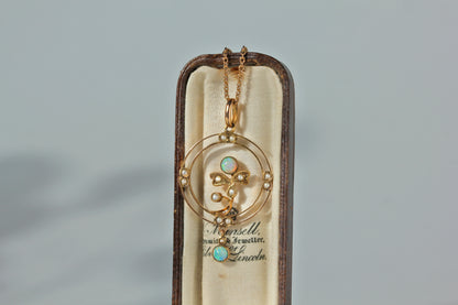 Antique 9ct gold edwardian era pendant on a 9ct antique cable chain, featuring opals and pearls upon an openwork frame