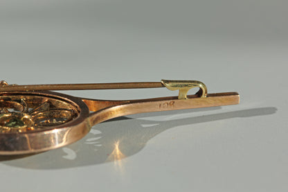 A close up of an antique clasp details, with gold '9CT' hallmark on the stem of the brooch 