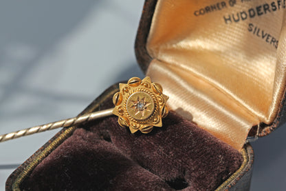 Antique celestial diamond stick pin displayed in a vintage jewellery box
