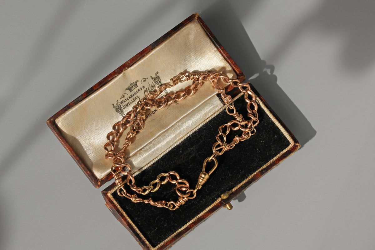 Antique fancy link double strand bracelet, crafted in 9ct gold and displayed in an antique jewellery box