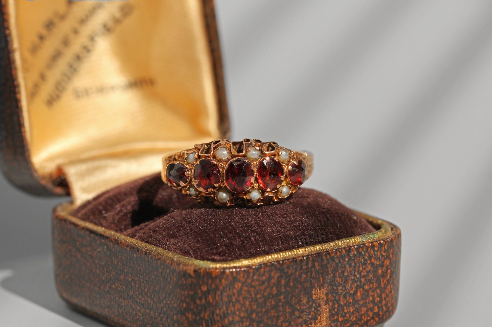 Antique gold garnet ring with seed pearl detailing in antique box
