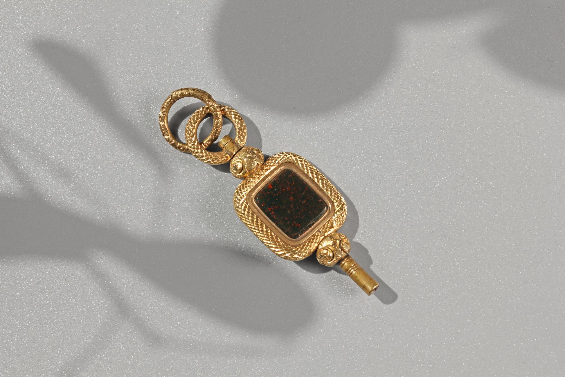 Large antique bloodstone watch key with textured split ring attachment
