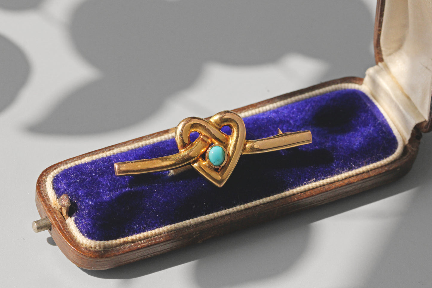 Antique turquoise heart brooch in 9 carat gold displayed on velvet jewellery box