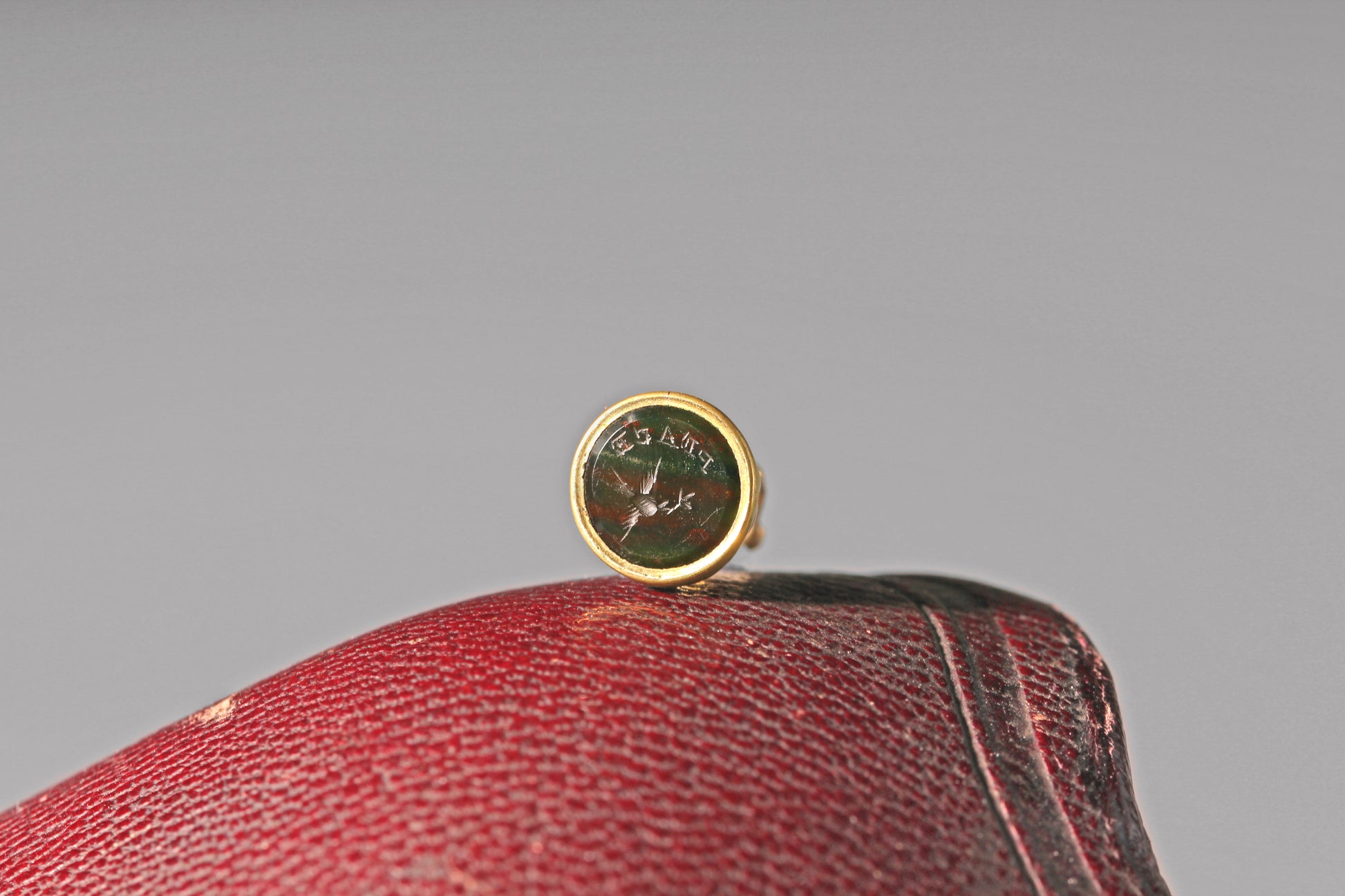 Antique bloodstone intaglio charm with dove carrying olive branch
