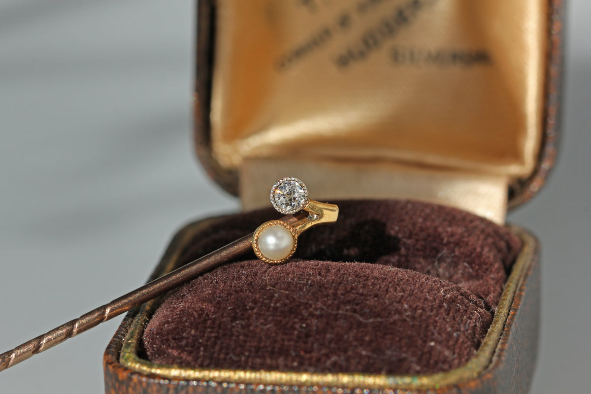 Antique old cut diamond and pearl stick pin, crafted in 18ct gold displayed on antique jewellery box