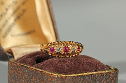 Antique 18ct gold ruby and diamond boat ring with openwork gallery, displayed in antique ring box 