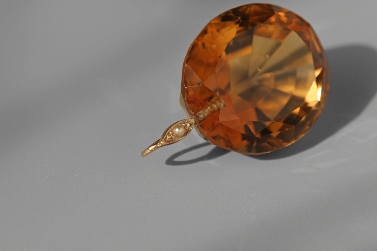 close up of a 9ct seed pearl bail loop on an antique faceted citrine stone