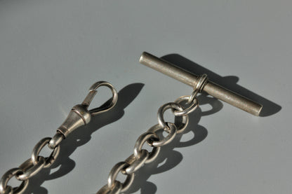 Antique sterling silver dog clip and bar on an Albert watch chain bracelet 