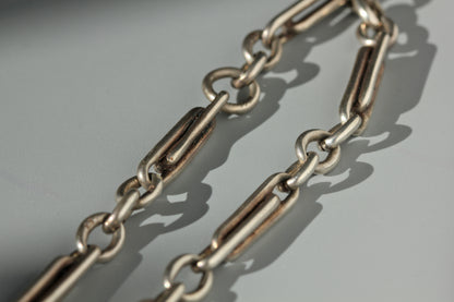 Trombone link details on an antique sterling silver watch chain 