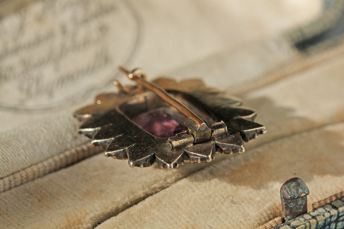 Antique tube hinge fastening on brooch in a beige lined antique jewellery box 