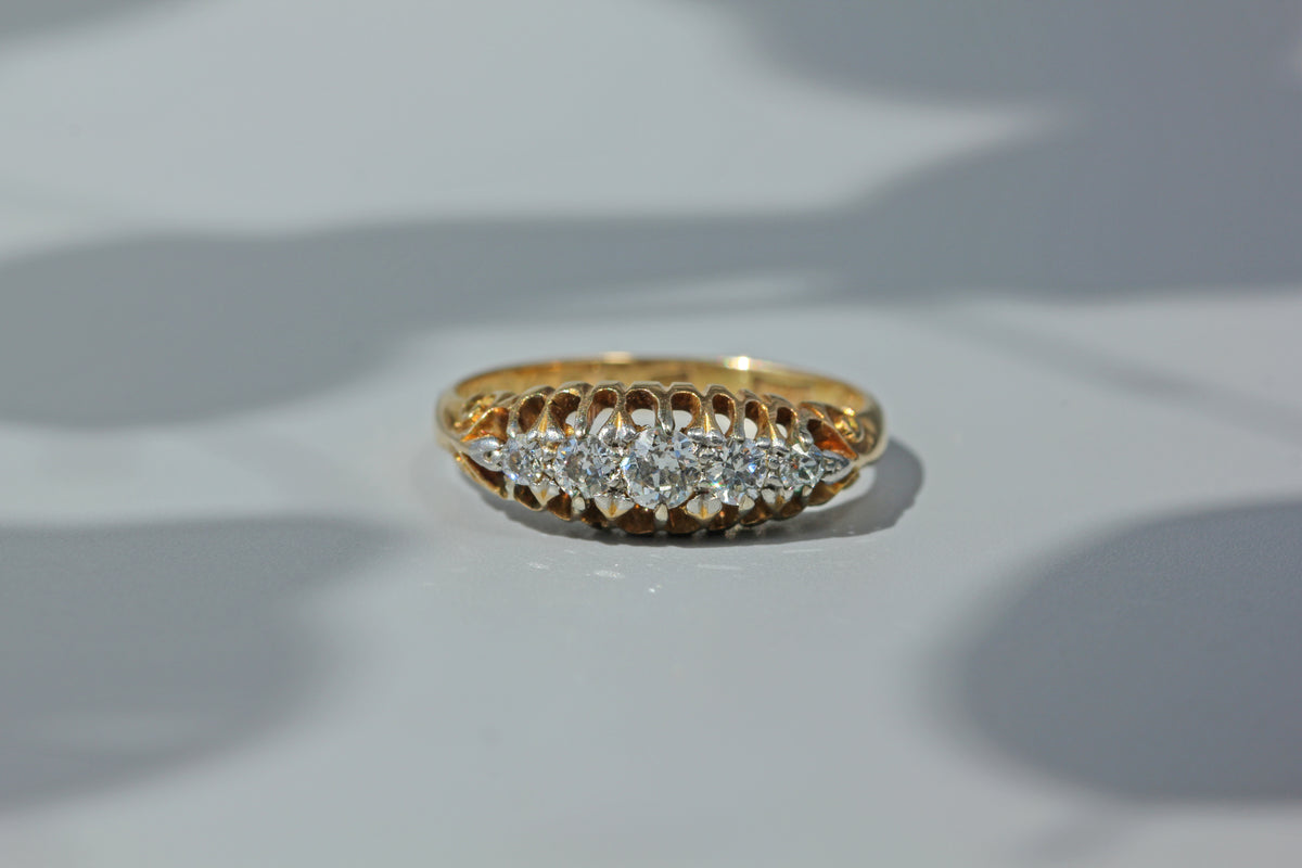 Antique art deco wedding band, studded with five diamonds and crafted in 18ct gold