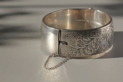 Details of bracelet clasp on vintage sterling silver bangle with etched floral details