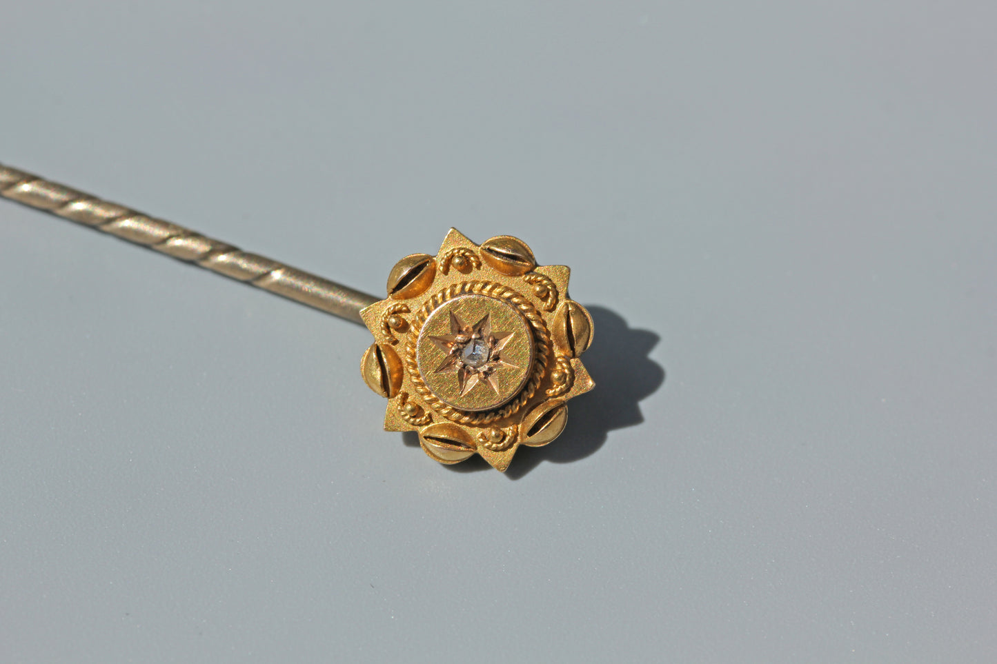 Detailed front view of a Victorian 15ct gold diamond stick pin

