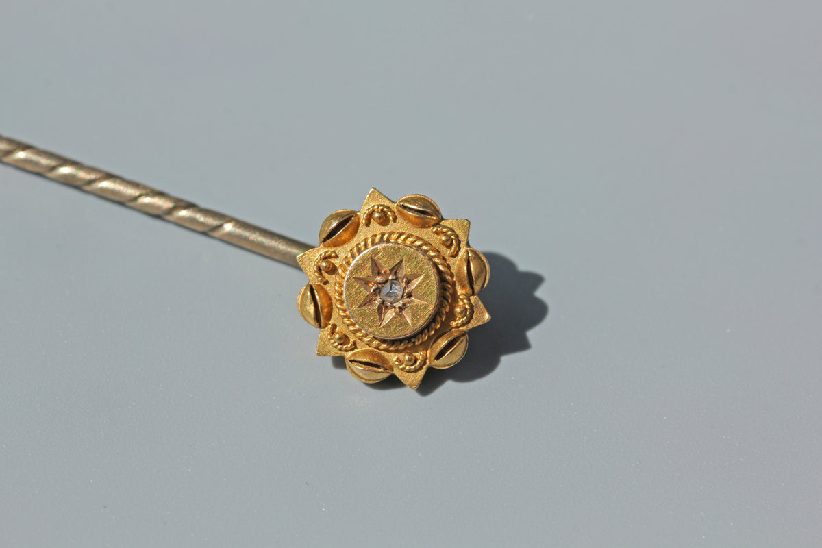 Detailed front view of a Victorian 15ct gold diamond stick pin
