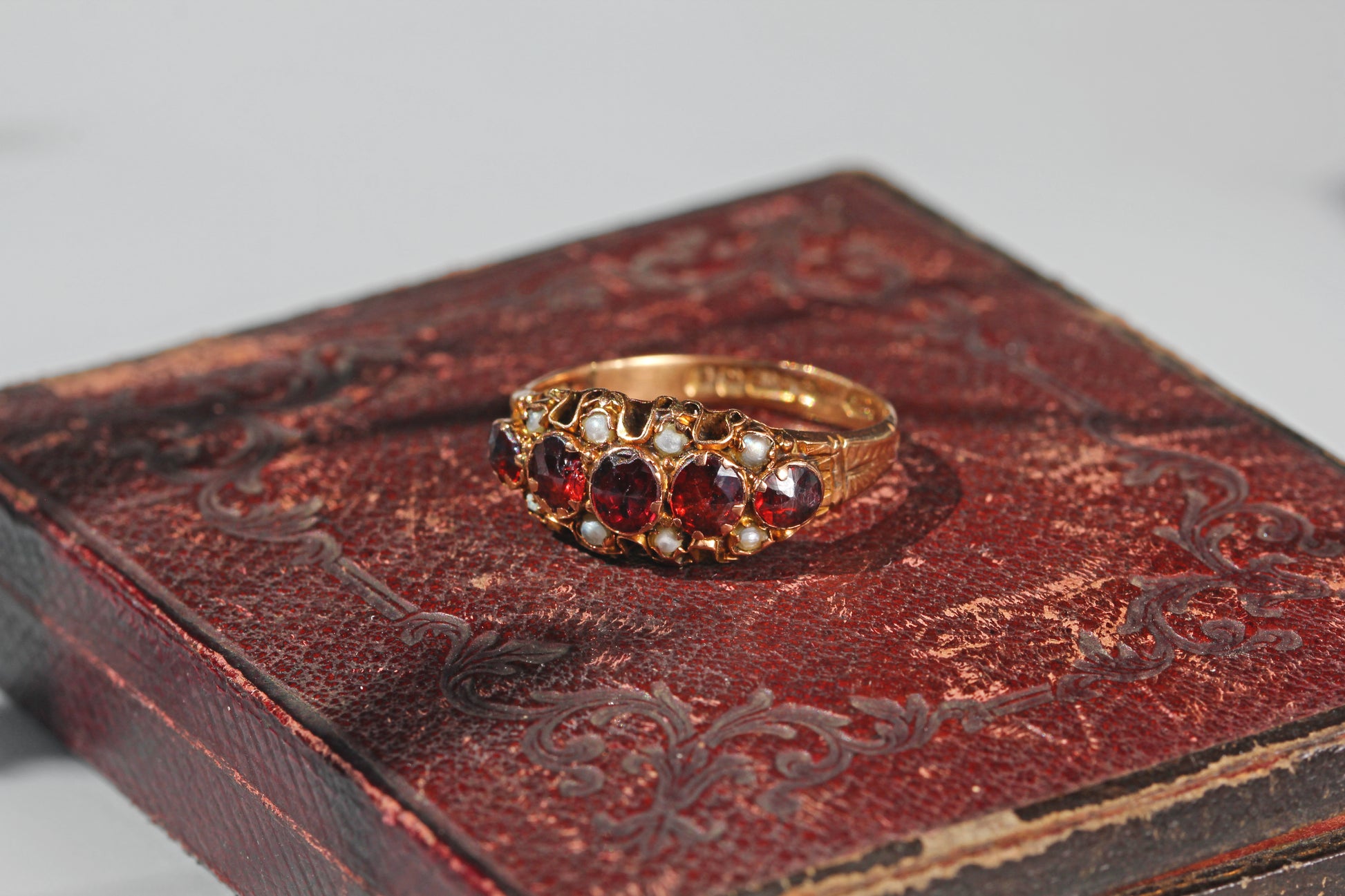 Victorian garnet and pearl five stone ring with engraved shoulders
