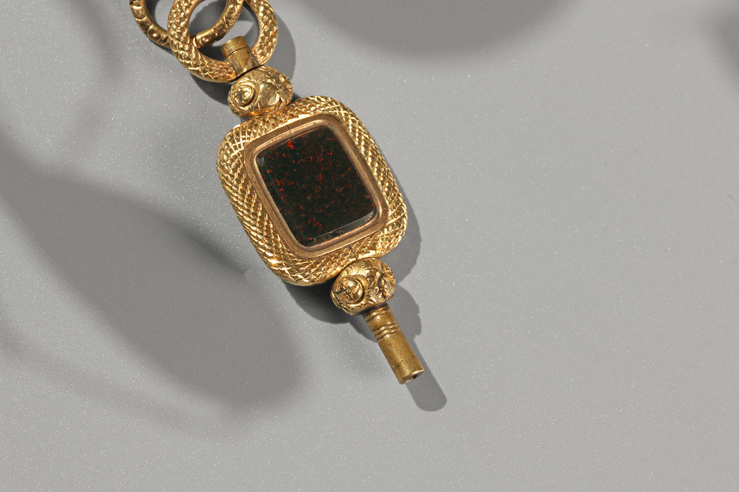 Antique fob watch key pendant with deep green bloodstone and red flecks
