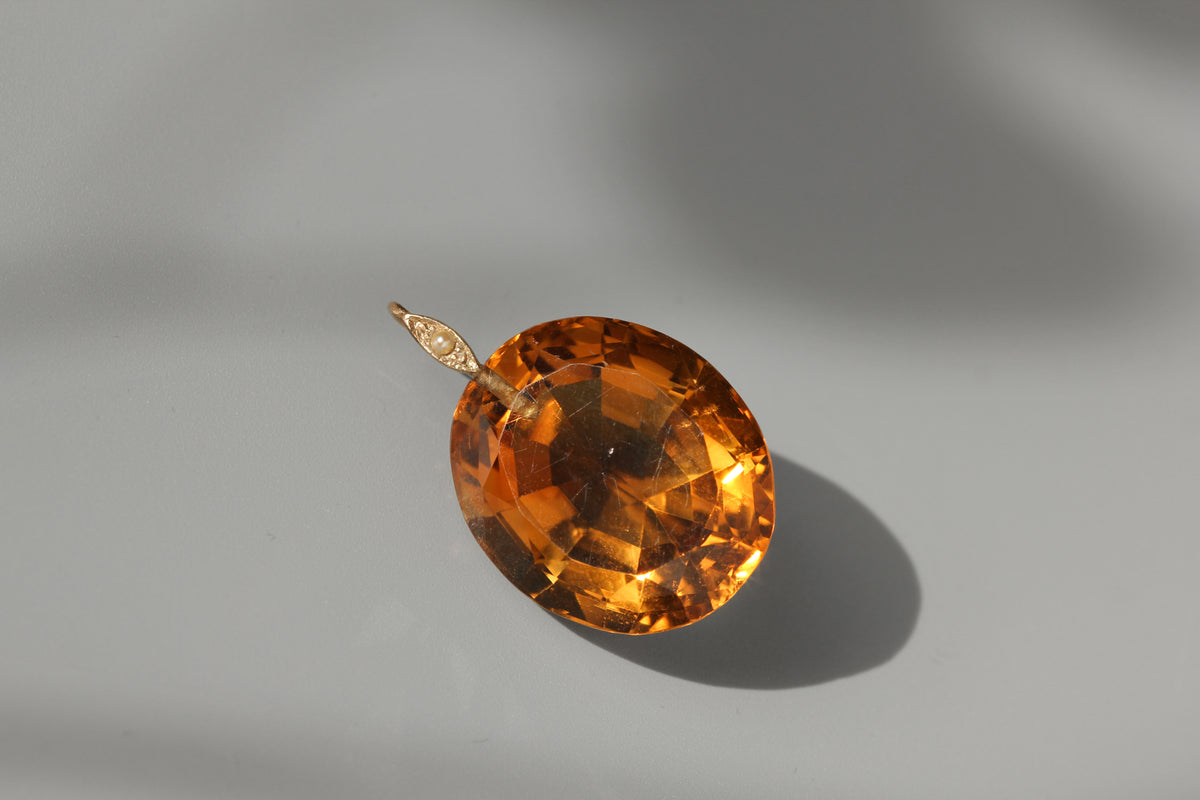 A huge 30ct citrine gemstone pendant, with 9ct gold pearl bail loop in the sunshine 