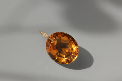 A huge 30ct citrine gemstone pendant, with 9ct gold pearl bail loop in the sunshine 