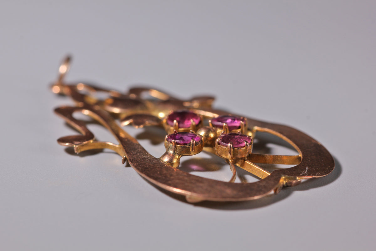 Edwardian pink tourmaline pendant with flowing openwork 9ct gold design
