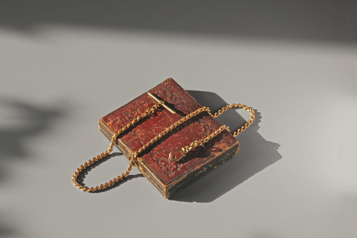 Antique Victorian rope link twist chain with T-bar in 9 carat gold on antique jewellery box