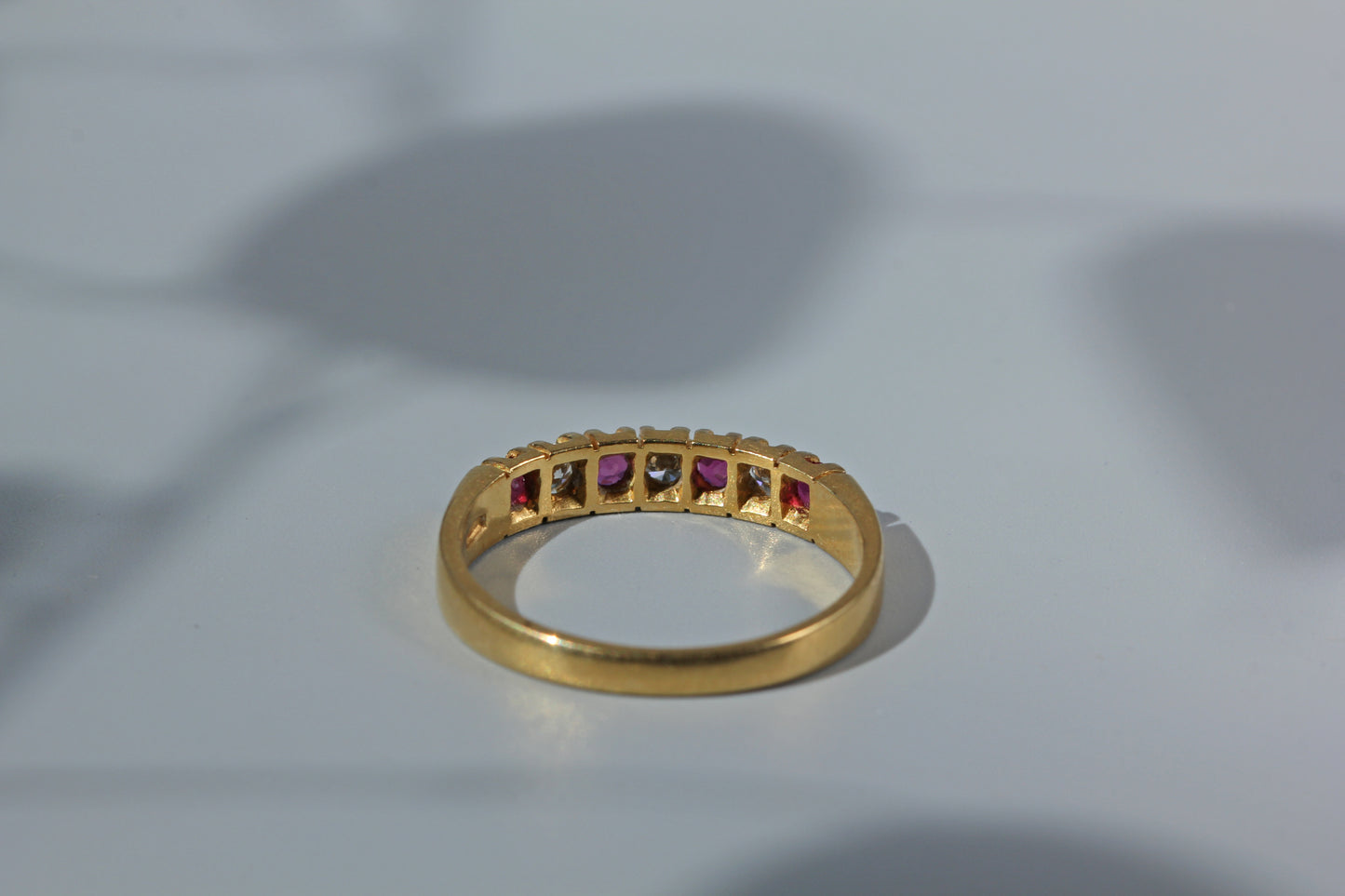 Rear view of open back setting on ruby and diamond ring 