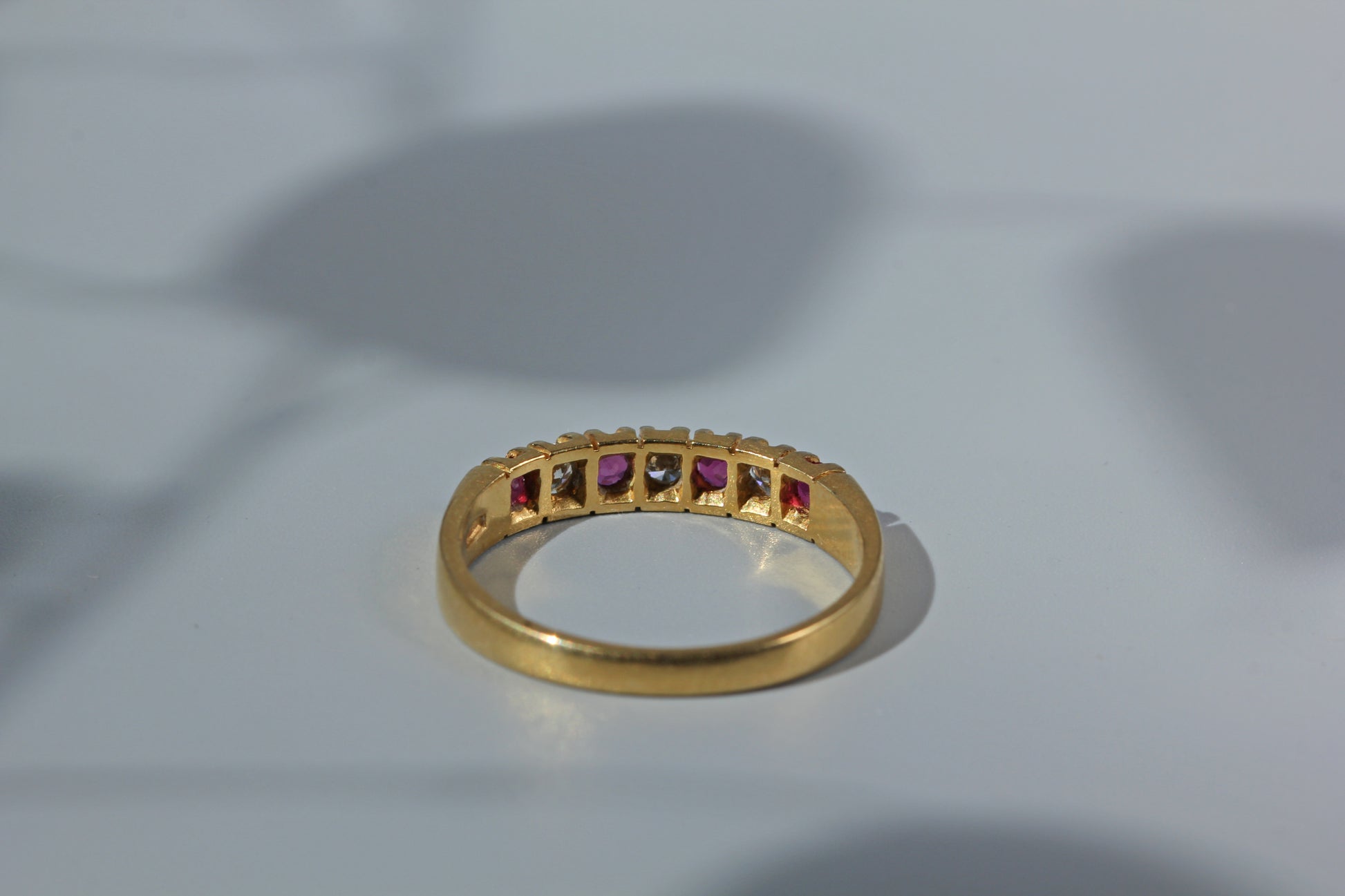Rear view of open back setting on ruby and diamond ring 