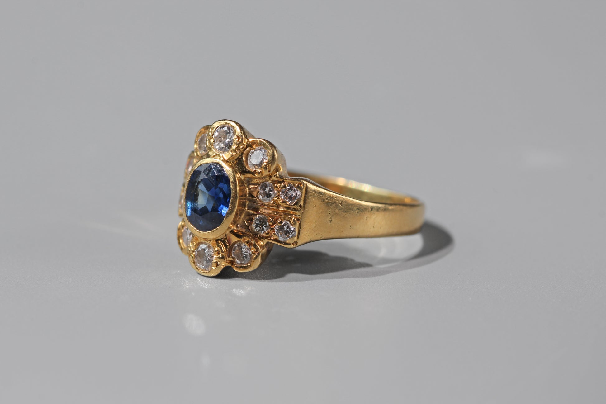Side profile of a vintage 18ct gold sapphire and diamond ring