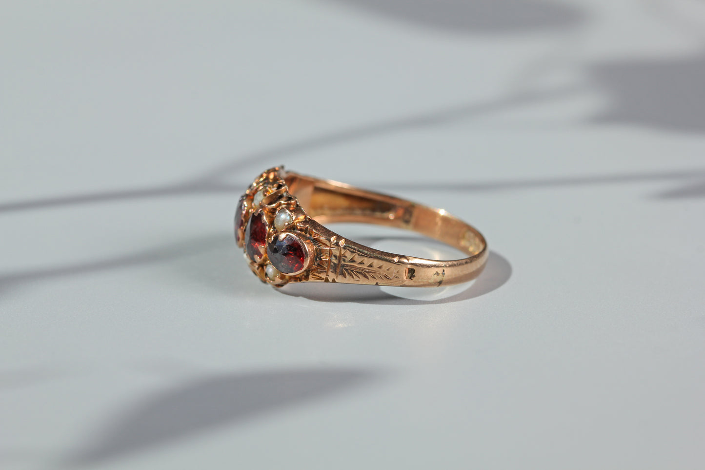 Side profile of antique garnet and pearl ring in 9ct gold
