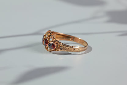 Side profile of antique garnet and pearl ring in 9ct gold
