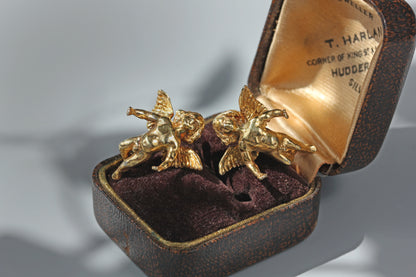 Sculptural winged cherub earrings with antique gold finish
