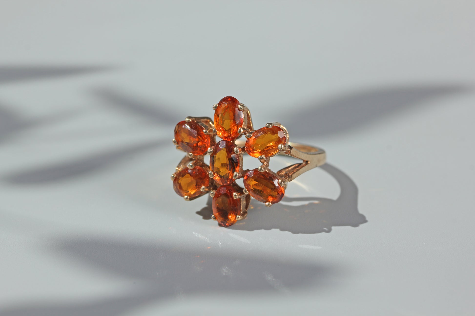 Openwork gallery detail on a vintage orange topaz flower cluster ring in 9ct gold
