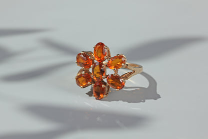 Openwork gallery detail on a vintage orange topaz flower cluster ring in 9ct gold
