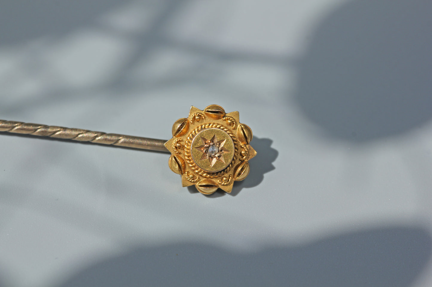 Close view showing the construction of an antique Victorian gold stick pin
