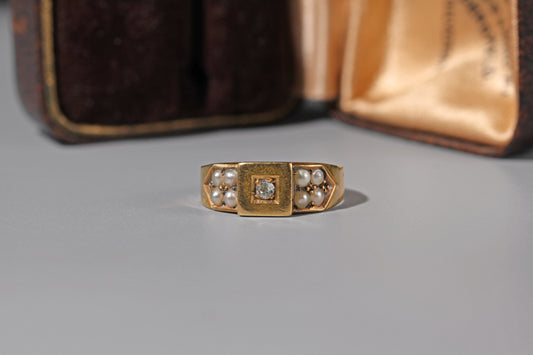 Antique 18ct gold band ring with central old cut diamond and split pearl shoulders
