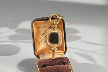 Antique bloodstone watch key pendant with ornate foliate detailing and split ring
