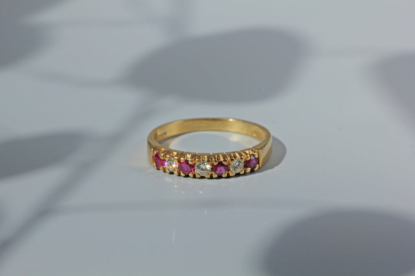 Front view of 18ct ruby and diamond wedding band, crafted in 18ct gold