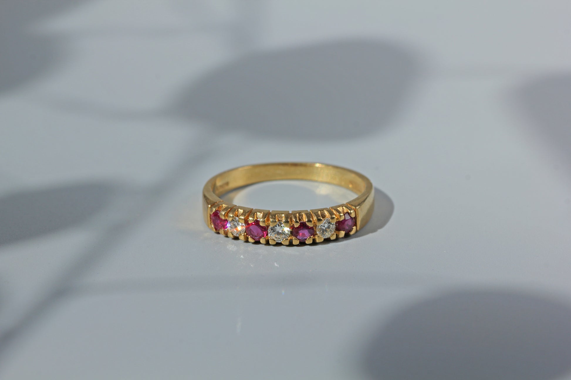 Front view of 18ct ruby and diamond wedding band, crafted in 18ct gold