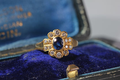 Front view of a vintage 18ct gold sapphire and diamond cluster ring