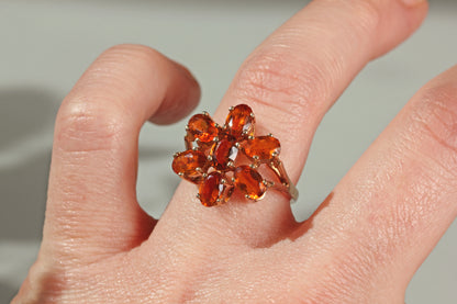 Bold 1970s floral cocktail ring with vivid orange topaz stones in warm amber tones