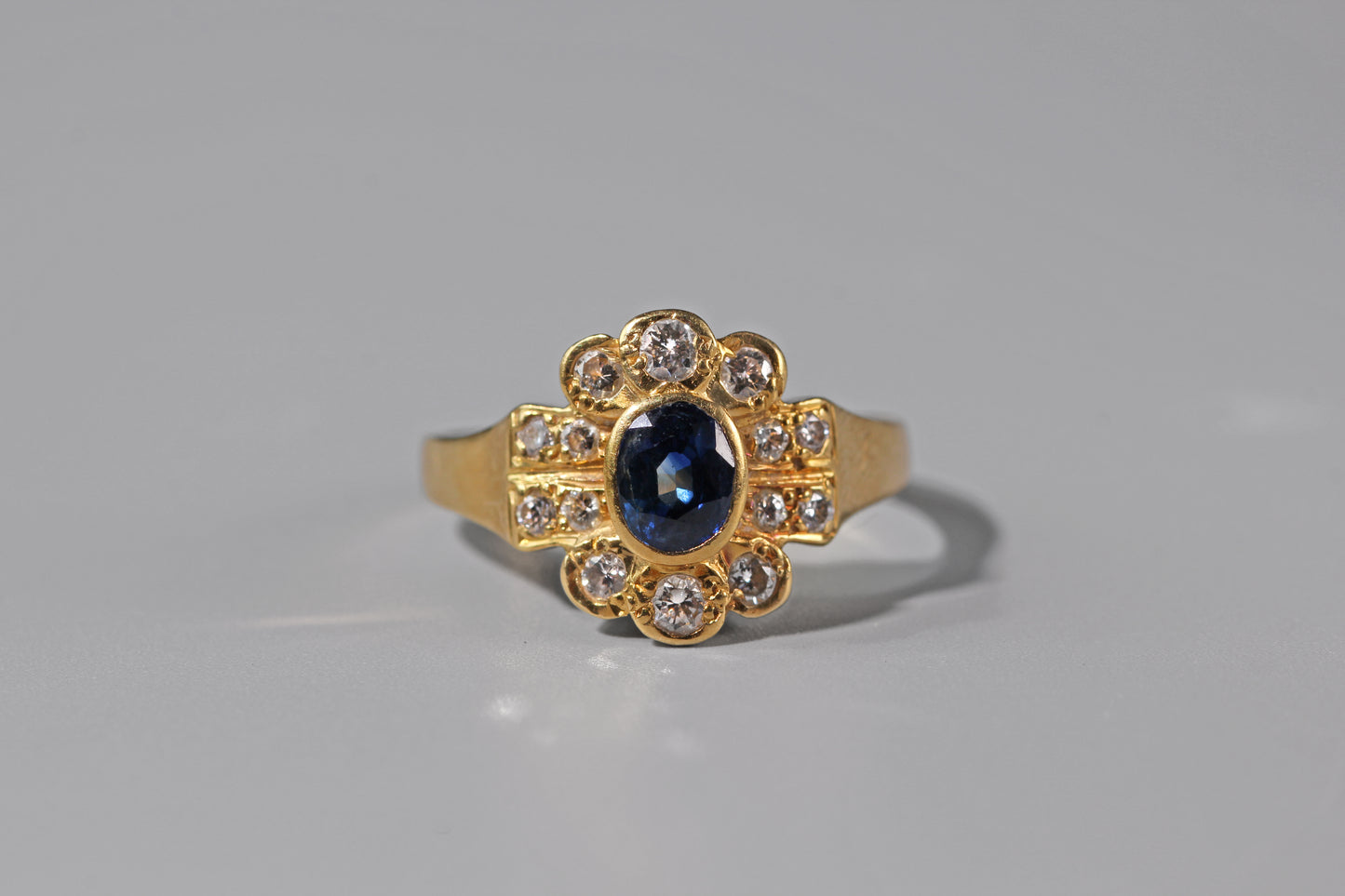 Close up of sapphire and diamond engagement ring in 18ct gold