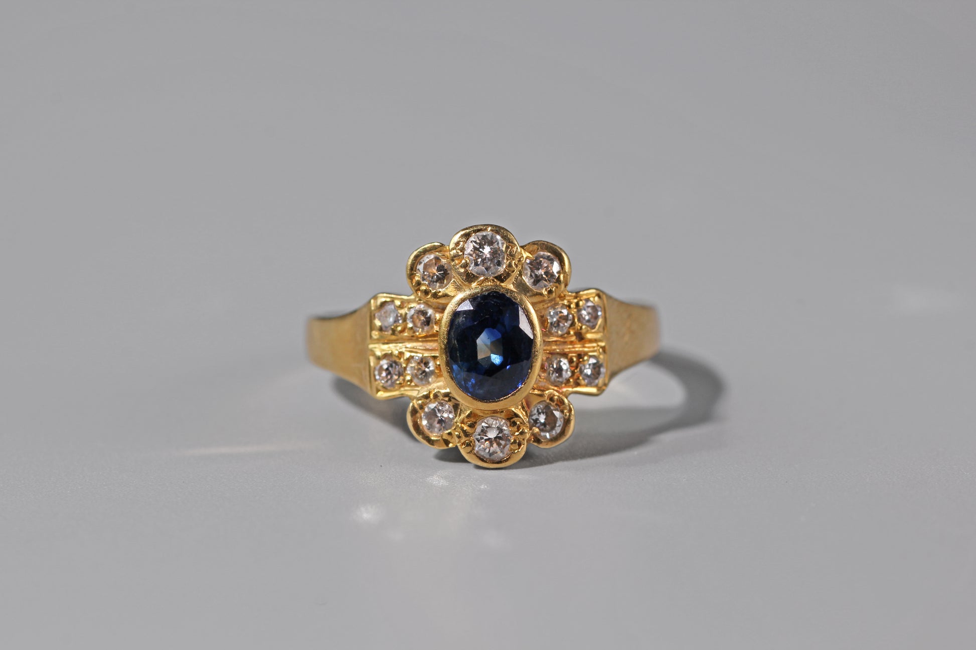 Close up of sapphire and diamond engagement ring in 18ct gold