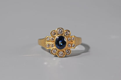 Close up of sapphire and diamond engagement ring in 18ct gold