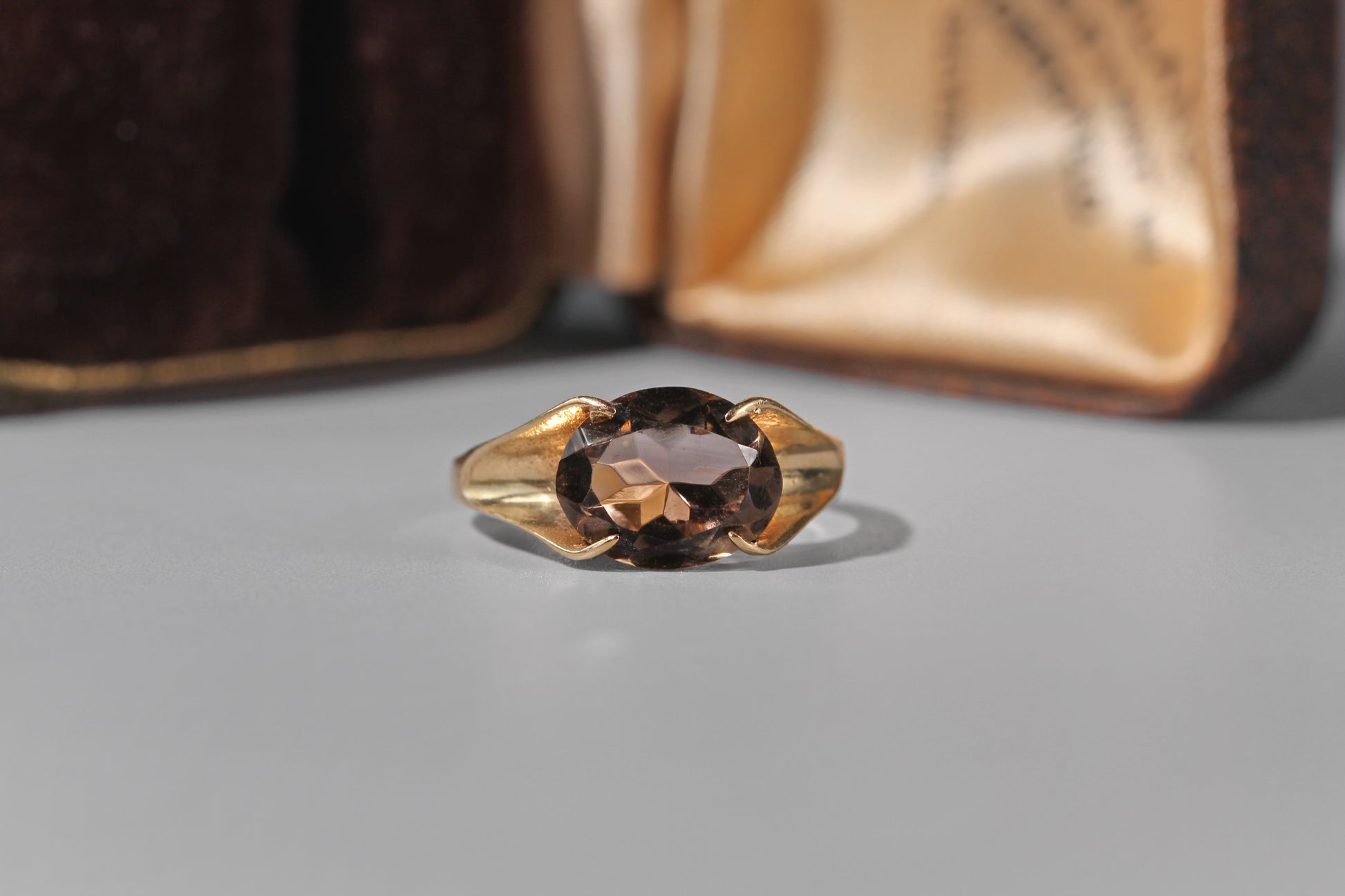 Oval smoky quartz solitaire ring in 9ct yellow gold
